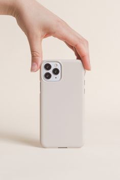 a hand holding an iphone case with two buttons