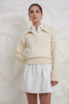 A soft and comfortable sweater to take you through the seasons. The breathable knit fabric means you can wear this ivory sweater on its own with shorts during warmer months, or you can layer it and style it with your favorite trousers when it's cold. A classic silhouette, you can pair this sweater with all of your favorite bottoms. For a comfortable and casual look, wear this sweater with some high-waisted jeans and your favorite sneakers. Knit Collar Drop shoulder V neckline Long sleeves Ribbed Ivy Clothing, Summer Style Guide, Collared Sweater, Faux Shearling Jacket, Knit Outerwear, Casual Party Dresses, Ivory Sweater, Balloon Sleeve Blouse, Comfortable Sweater