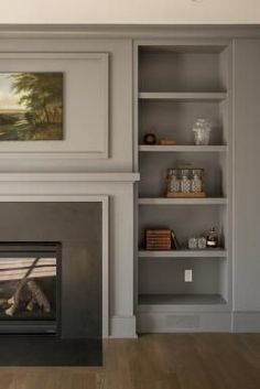 an image of a living room setting with fireplace and bookcases on the wall