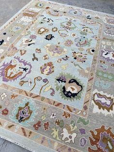 an area rug with many different colors and designs on it's sides, including flowers