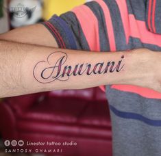 a man with a tattoo on his arm that says, suvani in cursive writing