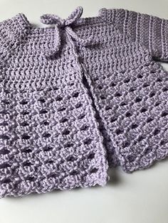 two crocheted baby sweaters are shown with the text, baby sweater free crochet pattern