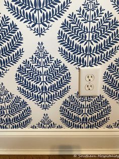 a blue and white wallpaper with two buttons on the left hand side of it