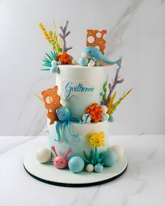 a three tiered cake decorated with sea animals