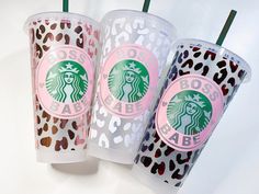 three starbucks cups with leopard print on them