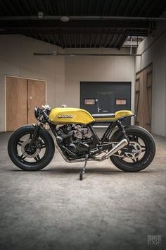 a yellow motorcycle is parked in a garage