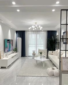 a living room with white furniture and blue curtains