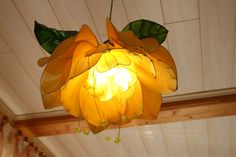 a yellow flower is hanging from the ceiling