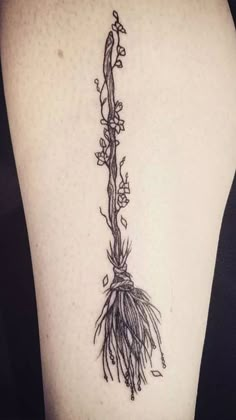 a black and white photo of a plant on the back of a woman's leg