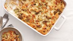 a casserole dish with broccoli, cheese and other toppings on a table