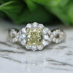 a yellow diamond ring sitting on top of a table