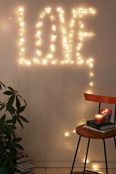 a chair sitting next to a table with a cake on it in front of a love sign