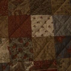 an old quilt with many different colors and patterns