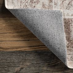 an area rug on top of a wooden floor next to a wood flooring board