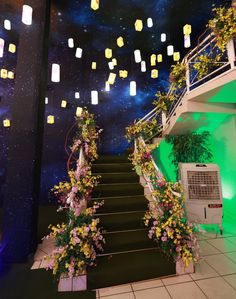 the stairs are decorated with flowers and lanterns