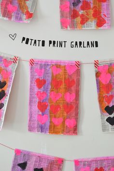 valentine's day art project for kids with paper hearts hanging from clothes pins on a line