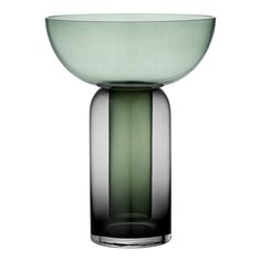 a green glass bowl sitting on top of a table