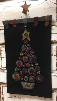 a christmas tree is hanging on the wall