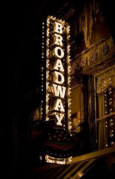 the broadway sign is lit up in black and white