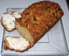 a loaf of bread sitting on top of a plastic tray next to two pieces of bread