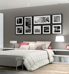 a white bed sitting in a bedroom next to pictures on the wall