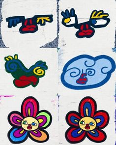 four different colored stickers on the side of a white wall with blue, red, yellow and green designs