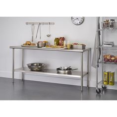 a stainless steel table with two bowls and pans on the shelf next to it