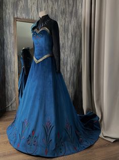 a blue dress is displayed in front of a mirror