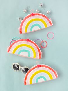 three paper plates with rainbows and sunglasses on them