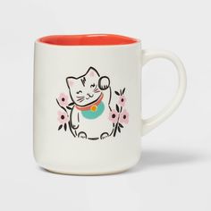 a white and red coffee mug with an image of a cat on it