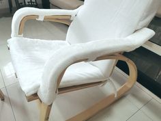 a white rocking chair covered in a blanket