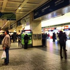 there are many people standing in the airport waiting for their bags to be picked up