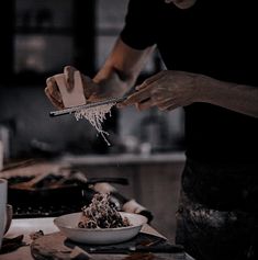 a person is scooping some food out of a bowl on the kitchen counter top