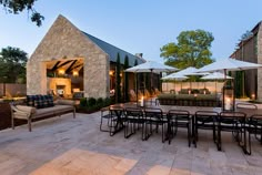 an outdoor dining area with patio furniture and umbrellas