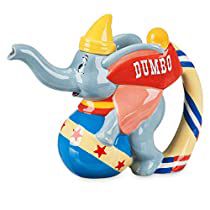 an elephant figurine with a dumbo hat on it's head sitting on top of a ball