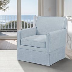 a blue chair sitting on top of a hard wood floor next to a white door