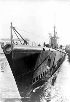 an old black and white photo of a submarine in the water