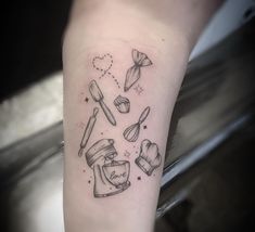 a tattoo on the arm of a person with cooking utensils and a jar