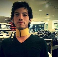 a man wearing a neck brace in a clothing store