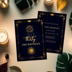 two black and gold 30th birthday cards on top of a table with candles, greenery and other decorations