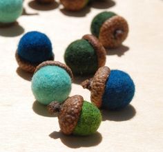 several different colored balls with pine cones on them