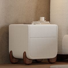 a white piece of luggage sitting on top of a wooden floor next to a lamp