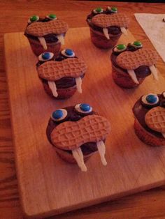 chocolate waffles with eyes and googly eyes are on a wooden cutting board