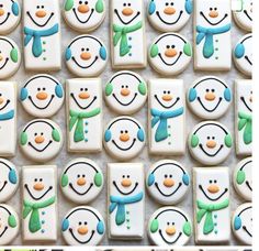 some decorated cookies with snowmen on them and one is frosted in icing