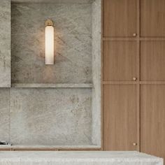 a bathroom with marble walls and wooden cabinets