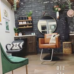 a chair and mirror in a room with brick walls