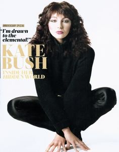 a magazine cover with a woman sitting on the floor in black clothes and her hands up