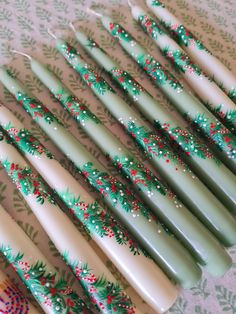 six green and white christmas themed toothbrushes on a table