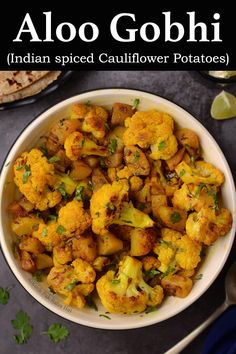 a white bowl filled with cauliflower and topped with cilantro