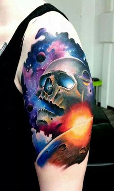 a person with a tattoo on their arm that has an image of a skull in space